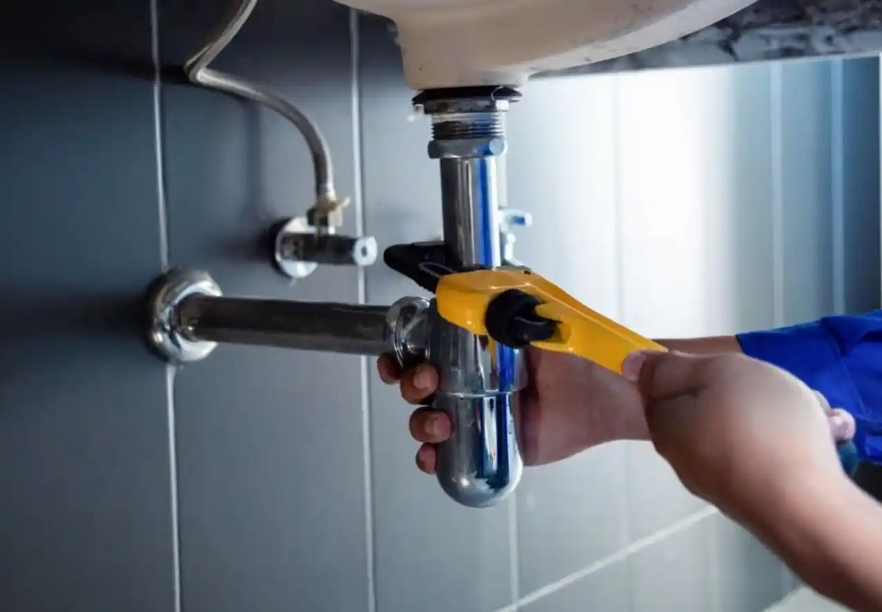 Dallas plumber installing a modern bathroom faucet for improved water efficiency
